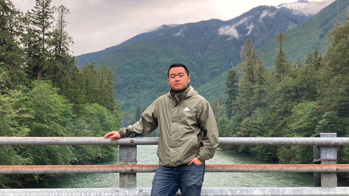 Haoran Zheng outdoors by a mountain river